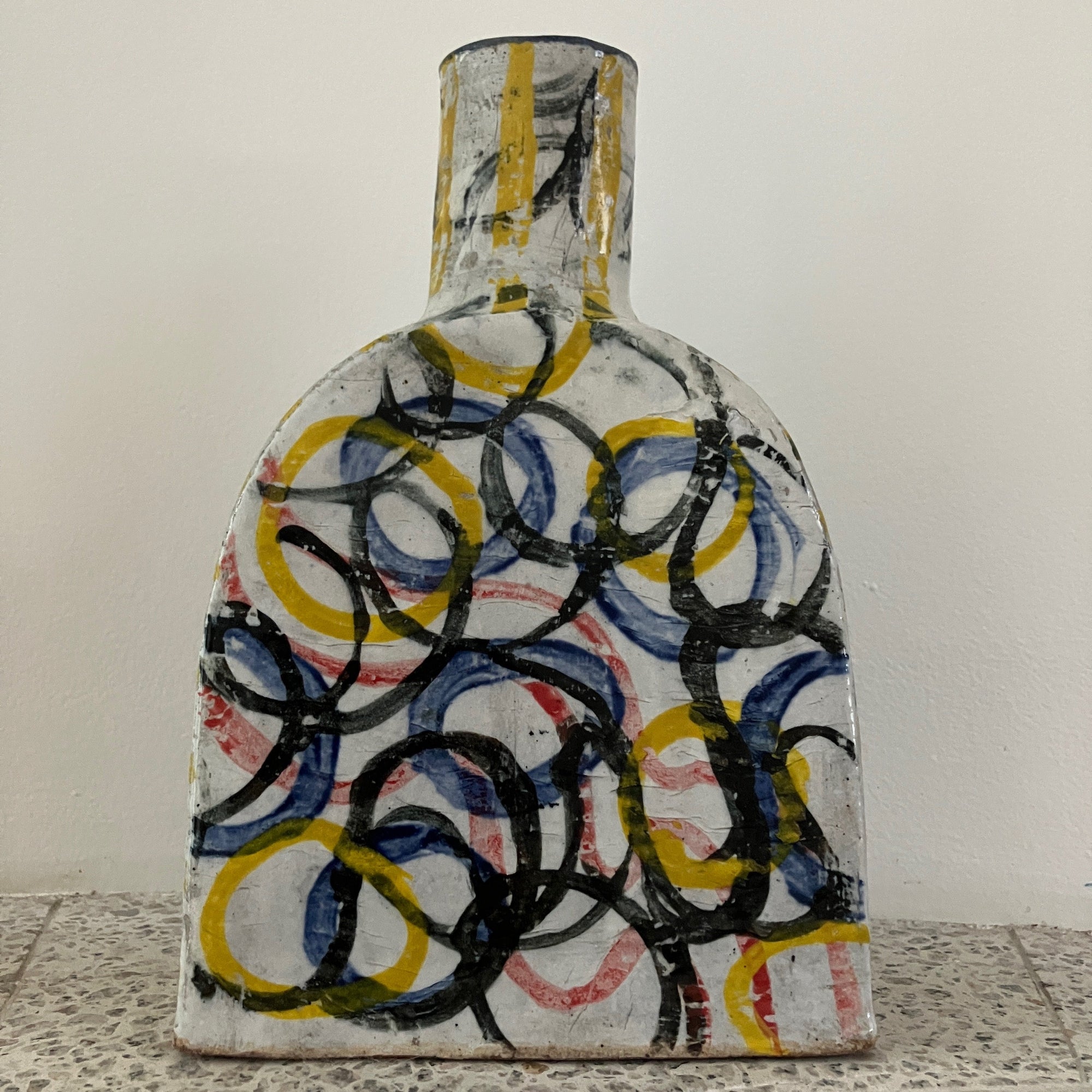 Decorative ceramic plate with abstract design on a textured surface