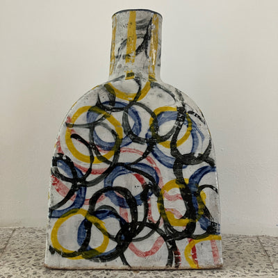 Decorative ceramic plate with abstract design on a textured surface