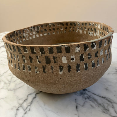Ceramic bowl with textured design on a marble surface
