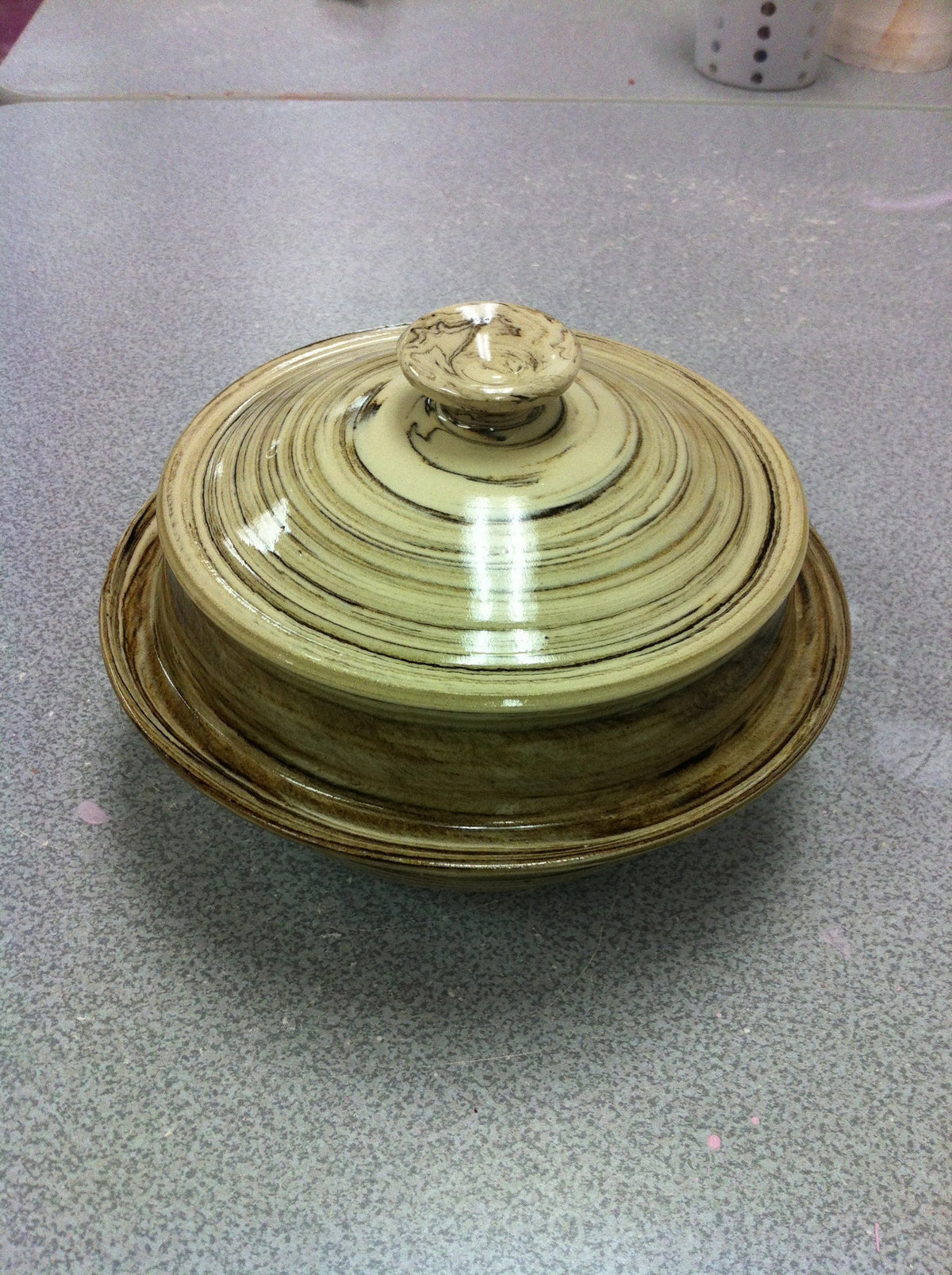 Lidded jar with marbling effect.