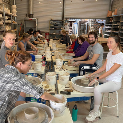 Students working on pottery wheels at Echo Art Studio in Los Angeles, pottery making